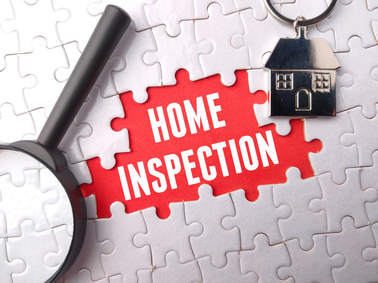 Puzzle says home inspection and shows magnifying glass and keychain