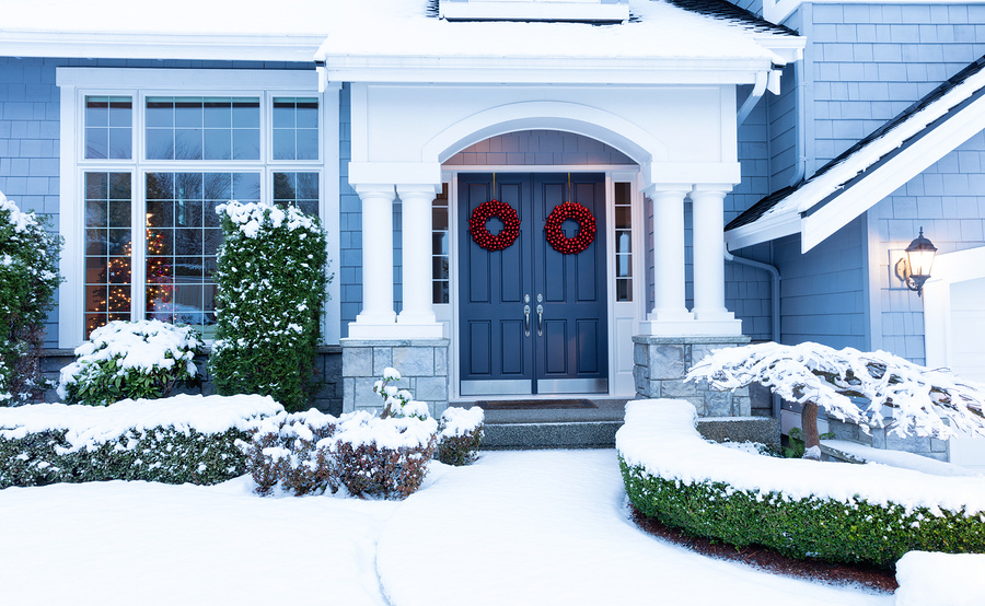 bigstock--160769114 Walkway to a fresh blanket of snow on residential home during the winter holidays.